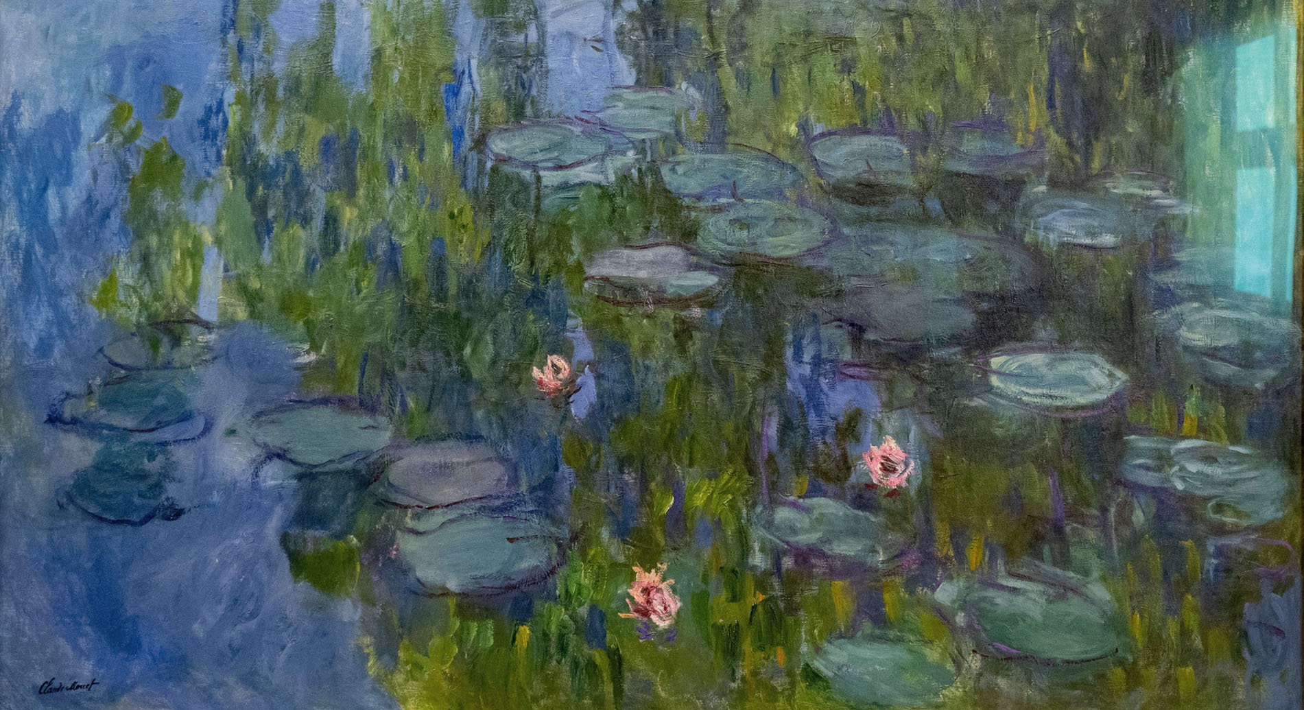 Munich, Germany - 29 Mar 24: Claude Monet’s impressionist Water Lilies scene with lily pads and reflections, displayed in a framed museum exhibit at t