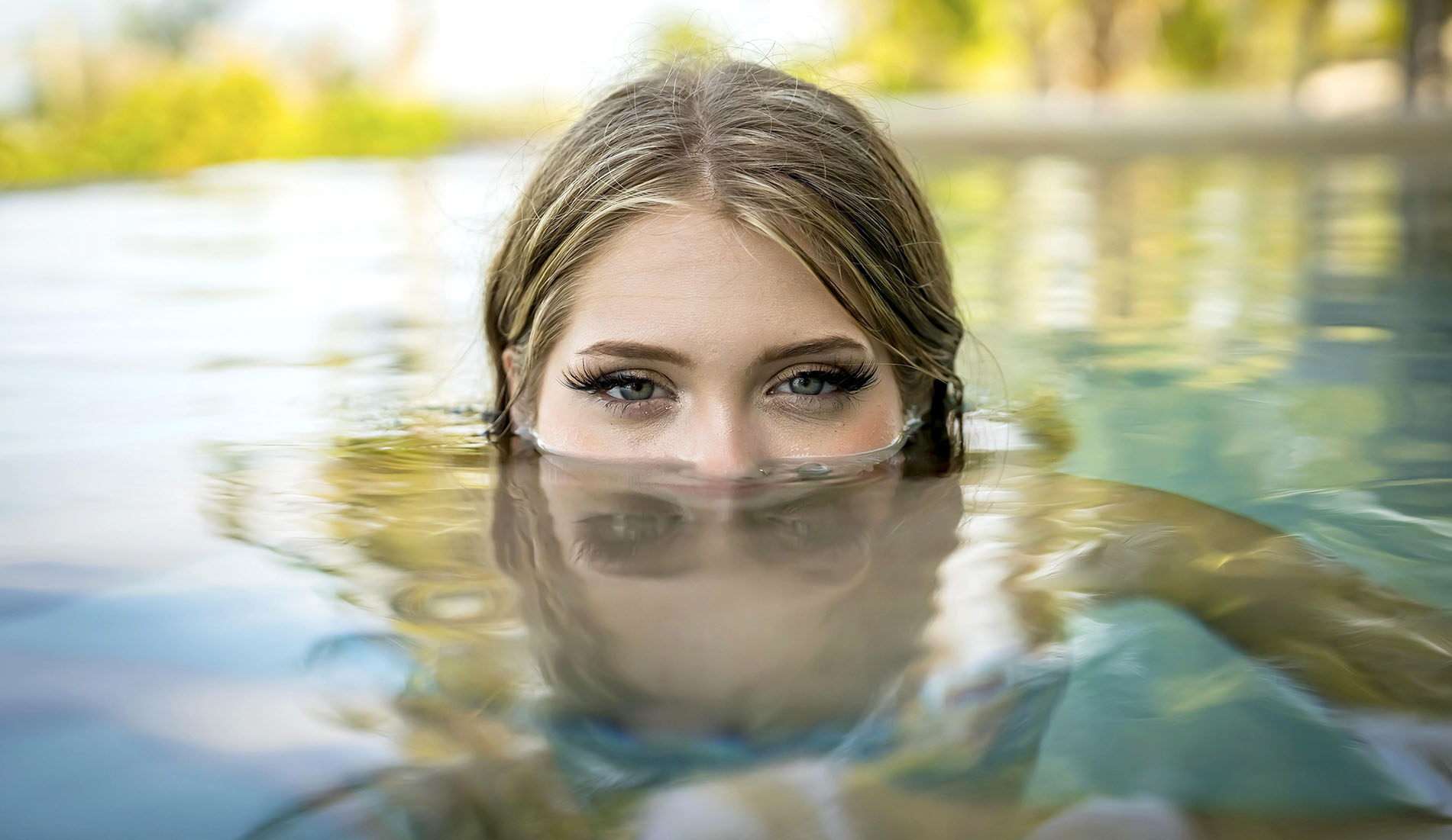 Young bikini model luxuriates in warm sun, cool pool, Yucatan Mexico vacation