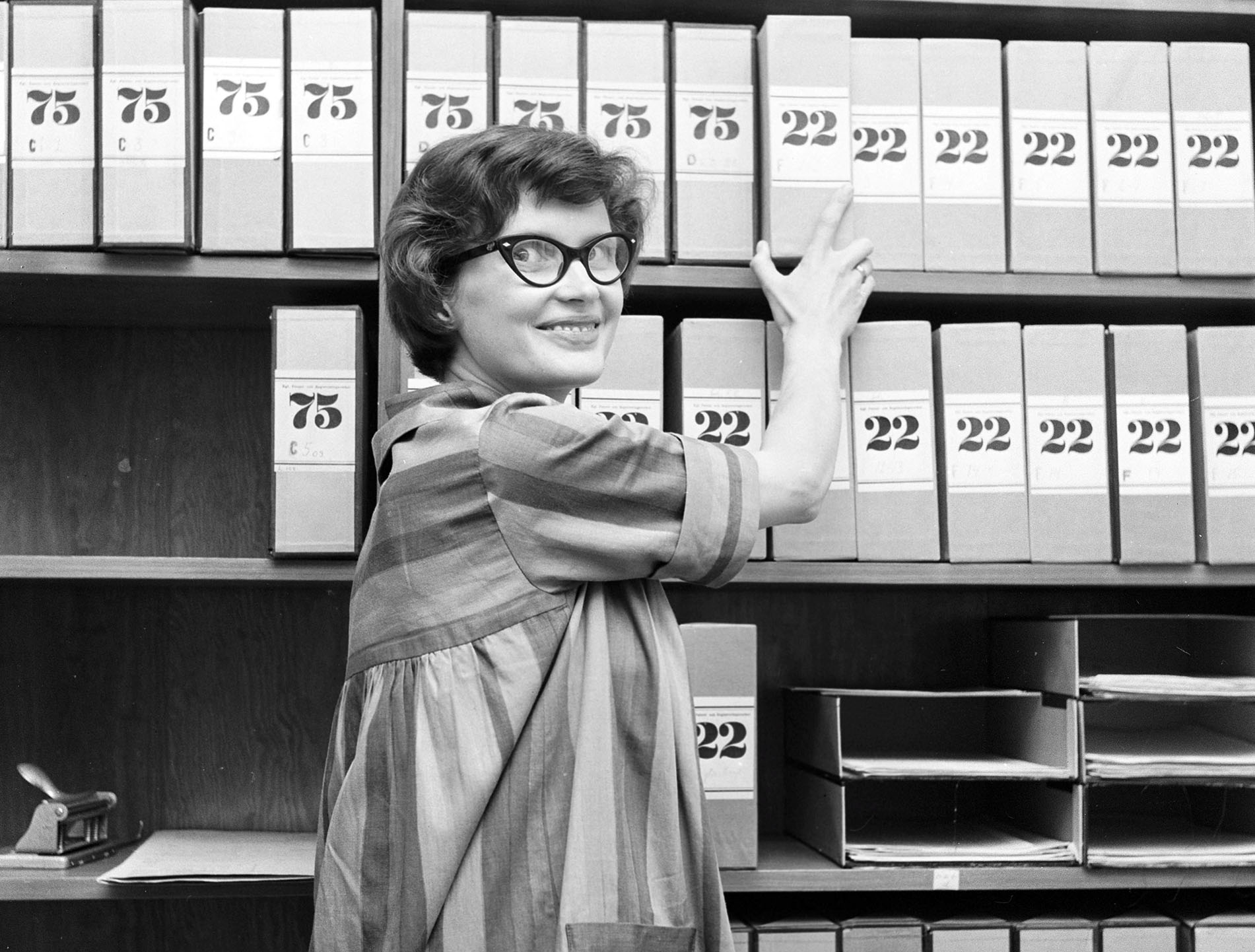 1950s glasses. A young woman in glasses and bows August 1959 is working in an archive