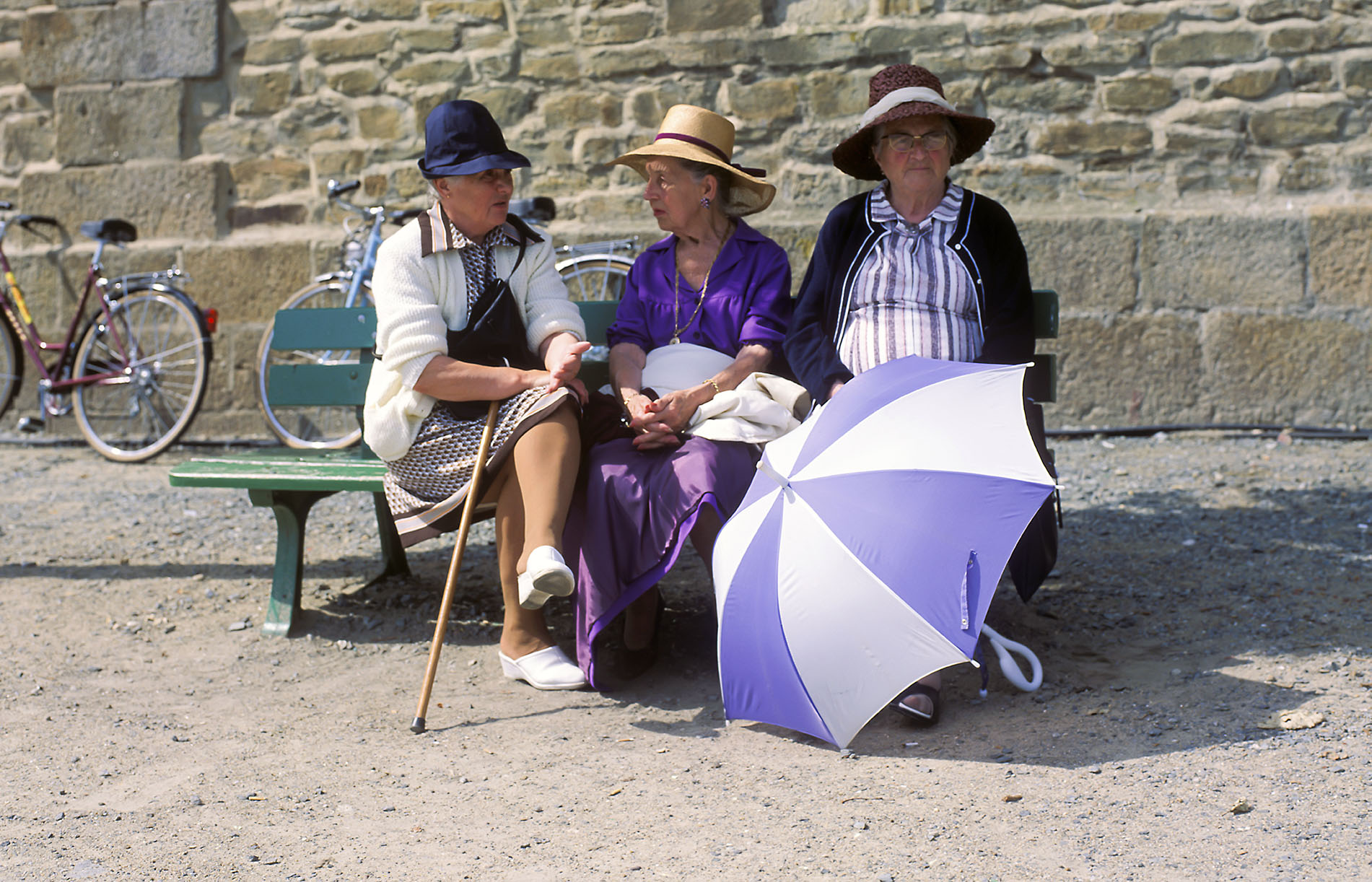 Women on a bench in front of the city wall of St.Malo, Brittany, France