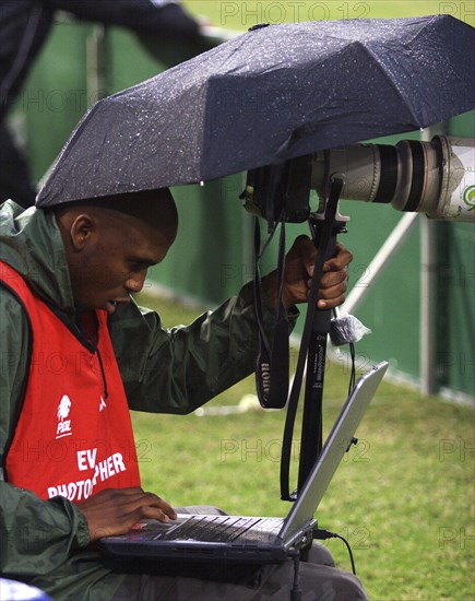 A photographer busy at work sending his pictures through to meet the deadlines.Hundreds of photogrpahers are expected to cover the 2010 World Cup.Thousands of local fans from South Africa attend the ABSA Soccer Cup final between the two largest teams, Orlando Pirates ( Black /White ) and Kaizer Chiefs or traditionally called the " Amakhosi " at Durban's ABSA stadium on 20 May 2006. South Africa hosts the 2010 World Cup and Durban is set to hold the semi final match in Durban.