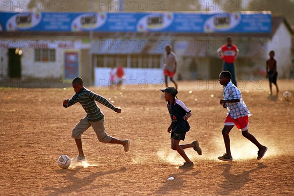 Soweto, South Africa                     April 19, 2001

Young boys kick up dust during an after school soccer game in Soweto, South Africa.