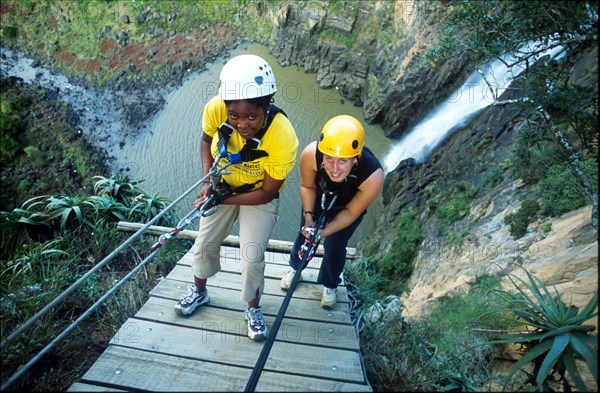 abseiling next to a waterfall