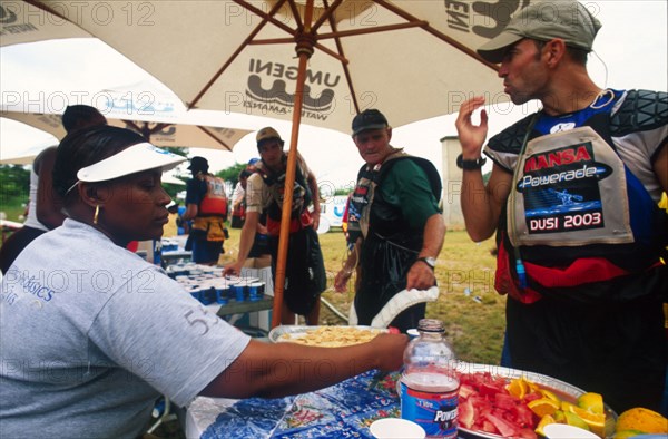 guy eating something and woman sitting at table with watermellon