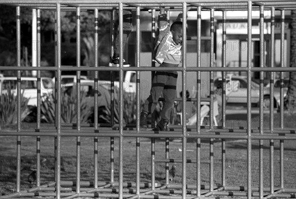 Cape Town, South Africa 1997
black children, boys, kids, playing, junglegym, climbing frame, xhosa