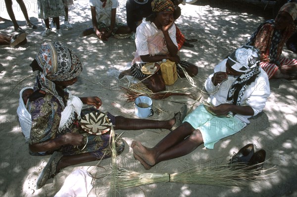 Ladies weaving baskets