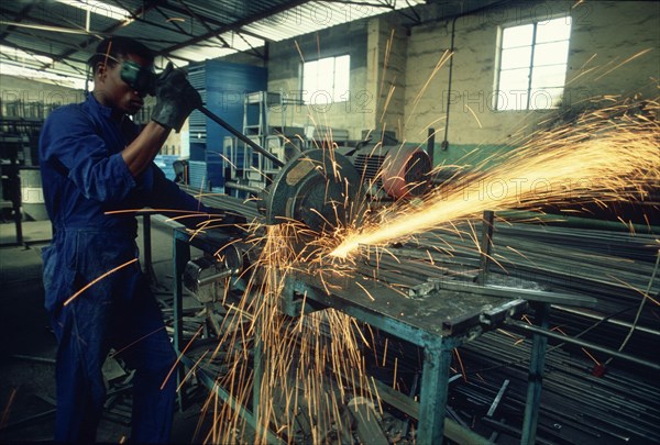 Man using a metal drop saw
\n