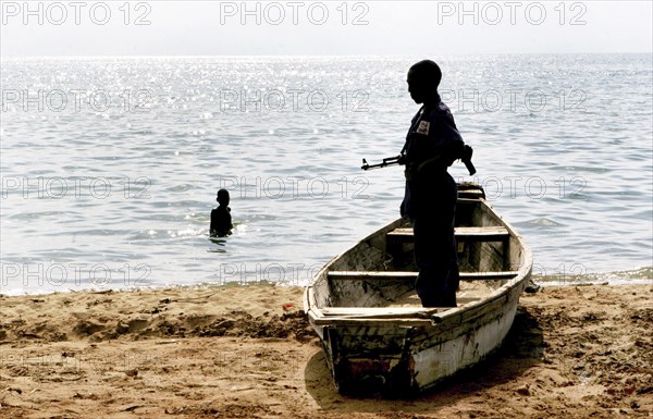 Burundi, A government soldier on a beach of lake Tanganjika near the border of Tanzania. Previous rebel movement CNDD-FDD was elected to parliament and now face the challange of reintegrating previous guarillas into society, February 2006.