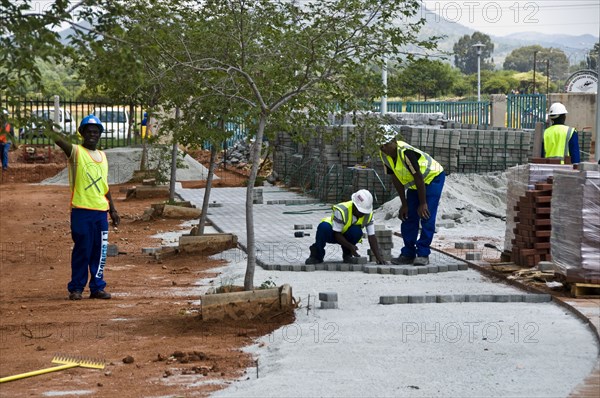 Workers lay paving at The Royal Bafokeng Sports Palace in Phokeng near Rustenburg.  The stadium will be used for 2010 FIFA World Cup Soccer.