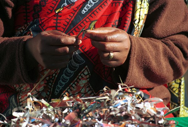 A Rwandan worker creates colourful beads from paper at Umtha Beads, a craft business run by David and Cheryl Milligan. The couple started the business after David was laid off work - one of many as companies were restructured in the new South Africa. David now employes many previously unemployed women
necklaces, small business, entrepreneurship, beads