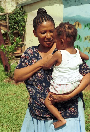 Child Welfare, Pietermaritzburg, South Africa 12/02/2001
Child Worker Fikile Gumede with AIDS orphans in Child WelfareÕs safe house in Pietermaritzburg. With between 49000 and 57000 Aids orphans expected in and around Pietermaritzburg by 2005, government and private sector intervention is needed both to help communities look after their own children, and to help institutions to cope with increasing numbers of children who find themselves out of family and out of community
parents, parent and baby, mother, child, families, family,