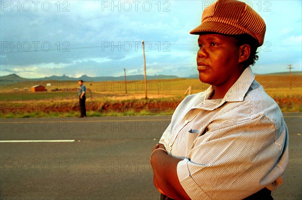 near Bergville, KwaZulu-Natal, South Africa, January 1993
women, girls, girl, lady, ladies, hat,  hats, cap, caps, face, facial features, road, roads