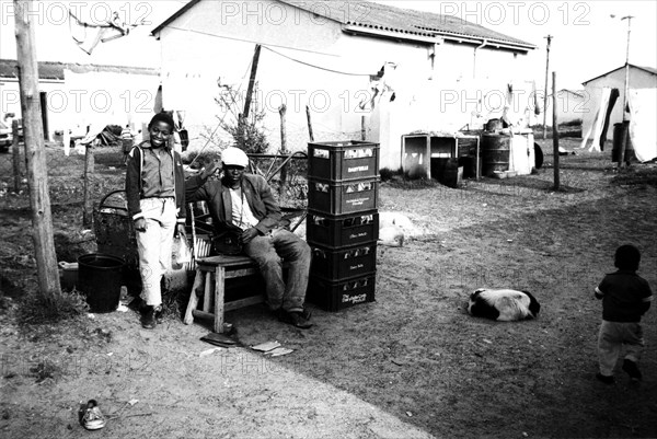 Langa, Cape Town, South Africa, 1989
young xhosa boys, men, black townships, dog, dogs, township, townships, location, locations, poverty, run-down