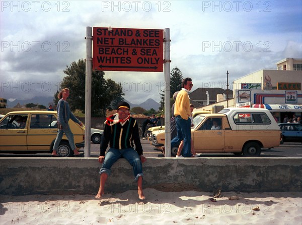 The Strand, Cape Town, South Africa, 1989

whites only sign, signs, signage, politics, political system, systems coloured people, demonstrations against apartheid, beach demonstrations, cars, shops, beach, protest, protests, bias, bigotry, discrimination, illiberality, one-sidedness, partiality, racialism, sectarianism, segregation, unfairness, racism, racist