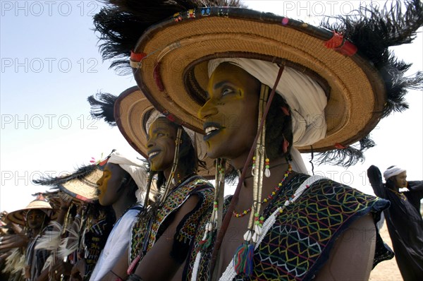 Wodaabe men perform a dance of male beauty at a festival in InGall, near Agadez in Niger on Friday Sept. 26, 2003. The Wodaabe, a nomadic West African tribe, value male beauty and are taught from an early age to look into mirrors to consider their appearance. The Wodabe men perform a dance, showing off the whiteness of their teeth and eyes, to compete for honour and selection as the most beautiful man by women of the tribe at a festival celebrated at the end of the rainy season. (Photo/Christine Nesbitt)