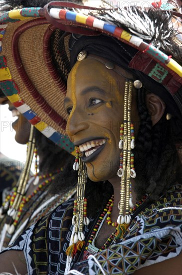A Wodaabe man performs a dance of male beauty, showing off the whiteness of his teeth and eyes at a festival in InGall, near Agadez in Niger on Friday Sept. 26, 2003. The Wodaabe, a nomadic West African tribe, value male beauty and are taught from an early age to look into mirrors to consider their appearance. The Wodabe men perform a dance to compete for honour and selection as the most beautiful man by women of the tribe at a festival celebrated at the end of the rainy season. (Photo/Christine Nesbitt)