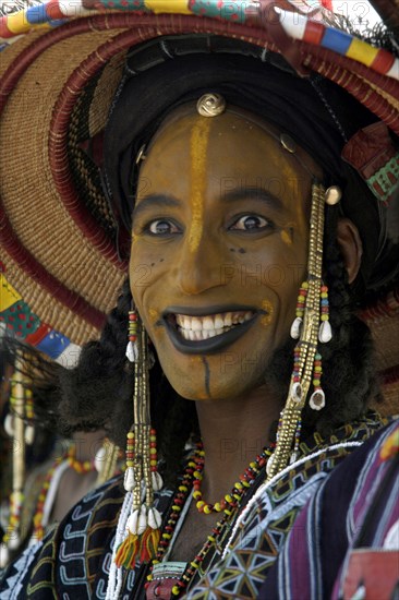 A Wodaabe man performs a dance of male beauty, showing off the whiteness of his teeth and eyes at a festival in InGall, near Agadez in Niger on Friday Sept. 26, 2003. The Wodaabe, a nomadic West African tribe, value male beauty and are taught from an early age to look into mirrors to consider their appearance. The Wodabe men perform a dance to compete for honour and selection as the most beautiful man by women of the tribe at a festival celebrated at the end of the rainy season. (Photo/Christine Nesbitt)