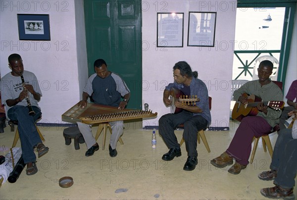 A Taarab orchestra plays in the Cultural Music Club in Stone Town, Zanzibar. It is difficult to determine the precise history of the Taarab music in Zanzibar.  However the legend has it that Taarab in Zanzibar was started by the Sultan Seyyid Barghash 1870-1888.  It was this ruler who started it all in Zanzibar that later spread over all of East Africa.  He imported a Taarab ensemble from Egypt to play in his Beit el-Ajab palace.  Later on he decided to send to Egypt Mohamed Ibrahim to learn the music and he also learned to play the instrument know by the name of Kanuni.  Upon his return he formed a Zanzibar Taarab orchestra.  In 1905 Zanzibar's second music society Ikwhani Safaa Musical Club was established and continues to thrive today with around 35 active members.  Ikwhani Safaa and Cultural Music Club founded at 1958 remained the leading Zanzibar Taarab orchestra.