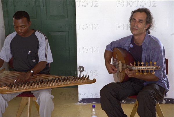 A Taarab orchestra plays in the Cultural Music Club in Stone Town, Zanzibar. It is difficult to determine the precise history of the Taarab music in Zanzibar.  However the legend has it that Taarab in Zanzibar was started by the Sultan Seyyid Barghash 1870-1888.  It was this ruler who started it all in Zanzibar that later spread over all of East Africa.  He imported a Taarab ensemble from Egypt to play in his Beit el-Ajab palace.  Later on he decided to send to Egypt Mohamed Ibrahim to learn the music and he also learned to play the instrument know by the name of Kanuni.  Upon his return he formed a Zanzibar Taarab orchestra.  In 1905 Zanzibar's second music society Ikwhani Safaa Musical Club was established and continues to thrive today with around 35 active members.  Ikwhani Safaa and Cultural Music Club founded at 1958 remained the leading Zanzibar Taarab orchestra.