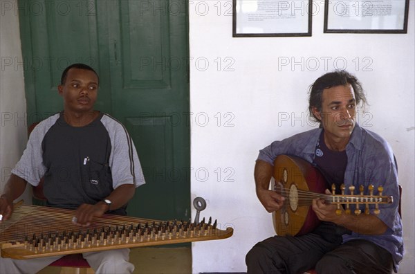 A Taarab orchestra plays in the Cultural Music Club in Stone Town, Zanzibar. It is difficult to determine the precise history of the Taarab music in Zanzibar.  However the legend has it that Taarab in Zanzibar was started by the Sultan Seyyid Barghash 1870-1888.  It was this ruler who started it all in Zanzibar that later spread over all of East Africa.  He imported a Taarab ensemble from Egypt to play in his Beit el-Ajab palace.  Later on he decided to send to Egypt Mohamed Ibrahim to learn the music and he also learned to play the instrument know by the name of Kanuni.  Upon his return he formed a Zanzibar Taarab orchestra.  In 1905 Zanzibar's second music society Ikwhani Safaa Musical Club was established and continues to thrive today with around 35 active members.  Ikwhani Safaa and Cultural Music Club founded at 1958 remained the leading Zanzibar Taarab orchestra.