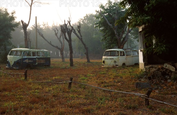 remains from the war - bombed out rondavels and vehicles