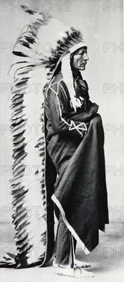 Standing Bear, Chief of the Sioux, wearing ceremonial robes and full length head-dress of eagle feathers
