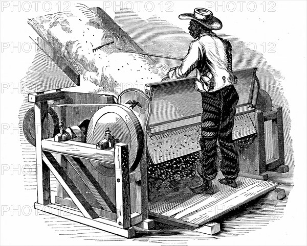 Saw gin for cleaning cotton being operated by barefoot black labourer