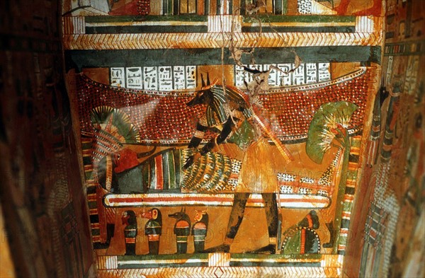 Jackal-headed god Anubis receiving dead king or noble