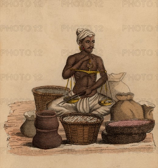 Indian betel dealer weighing his goods
