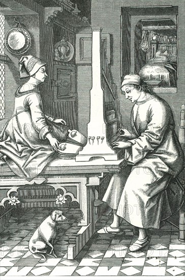 Man playing a portable organ while his wife operates the bellows