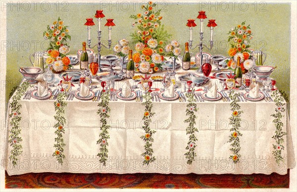 Table covered with a linen cloth and set for a buffet for ball or an evening party