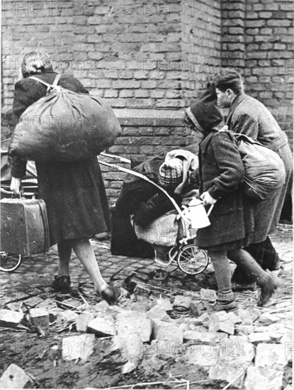 In a German town in 1945 people march in search of shelter