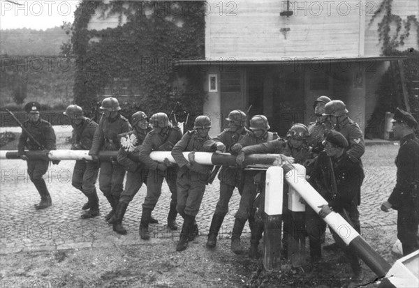 German Soldiers breaking down the border barrier
