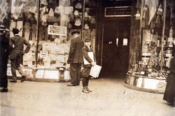 A young truant selling extras during school hours