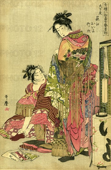 Two geishas dressing for a festival