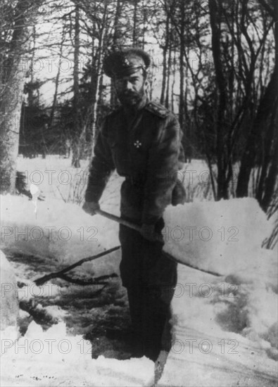 Russian Revolution: Emperor Nicholas II shovelling snow in the grounds of Tsarskoe Selo, Russia where he was imprisoned with the royal family in 1917