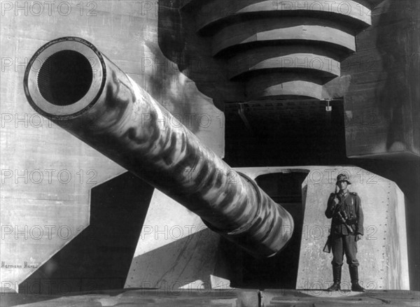 Barrel of a large gun with German soldier