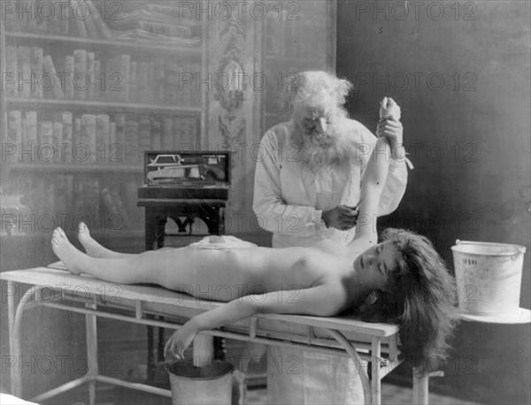 Nude girl on table being autopsied by doctor