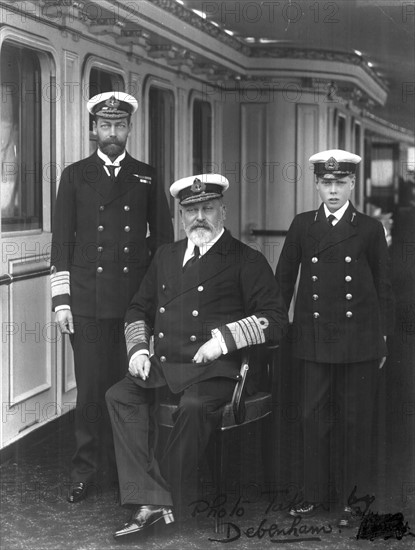 Three British monarchs. Edward VII (seated) his son, later George V, left, and his grandson, later Edward VIII, on the right, all in naval uniform. Photograph.