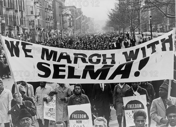 Marchers carrying banner lead the way as 15