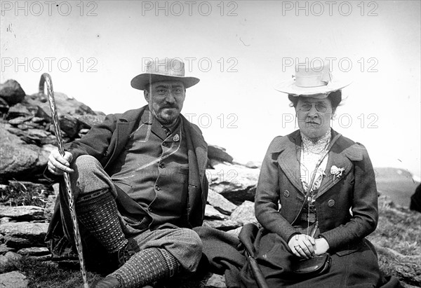 French man and woman sitting on a hillside circa 1900
