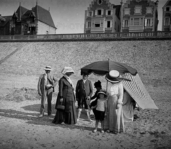 A French family group gathers on a beach in France
