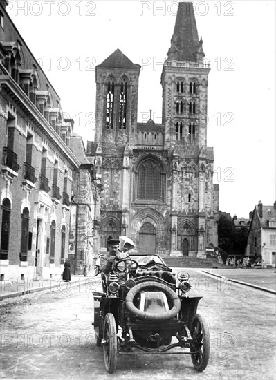 Car in front of Noyon Cathedral, France