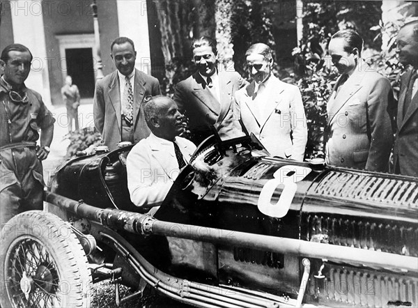 Mussolini driving an Alfa Romeo racing car