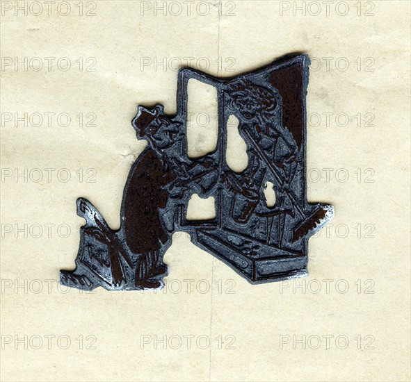 Lead block used to print a cartoon in a newspaper