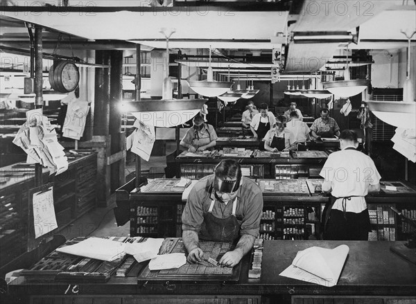 Typesetters and compositors put lead characters and letters into blocks for use in newspaper printing. American circa 1945