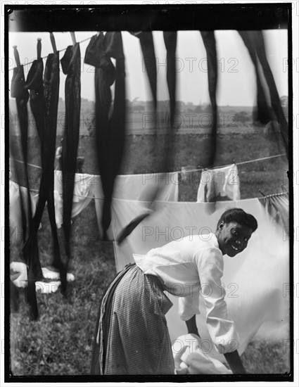 Young smiling Black woman Surrounded by Washing.