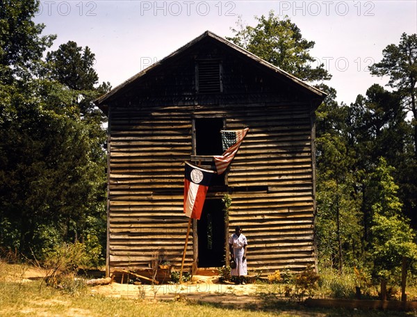 African American woman standing outside a house, 1942