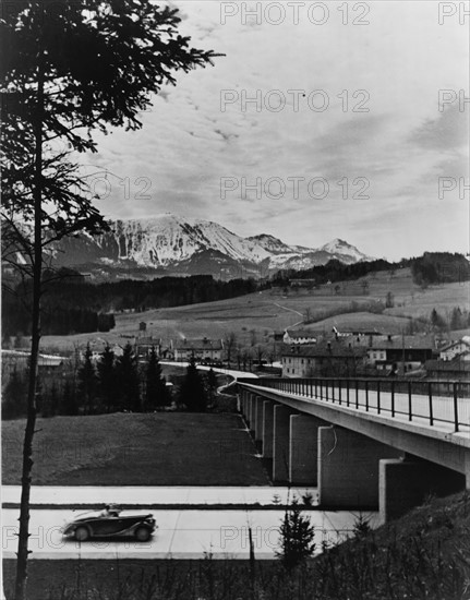 Automobile approaching overpass on the Autobahn, 1930s