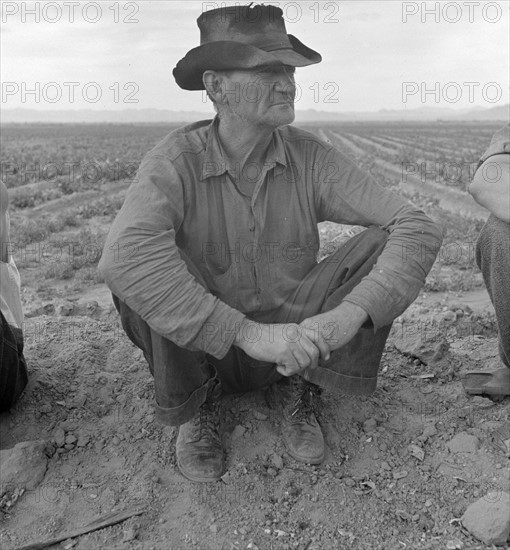 Harlingen (vicinity), Tex. Migrant worker sitting in front of fire. He lived with two other men workers By Russell Lee, 1903-1986, photographer 19390101.